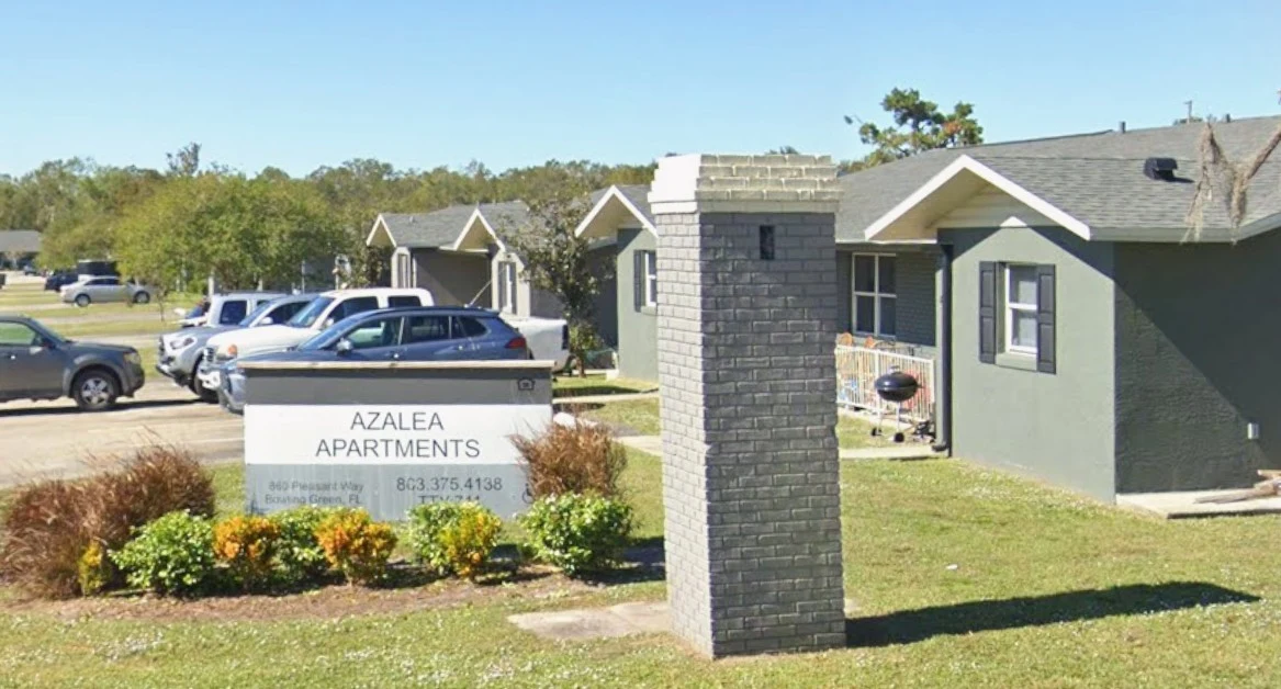 Azalea Apartments sign and homes in Bowling Green, Florida.